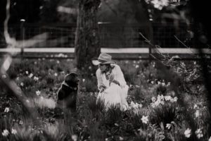 woman and dog in the daffodils