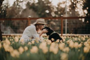 woman and dog in the flowers