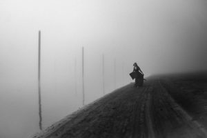 woman walking in fog by the river