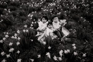 kids sitting in flower field