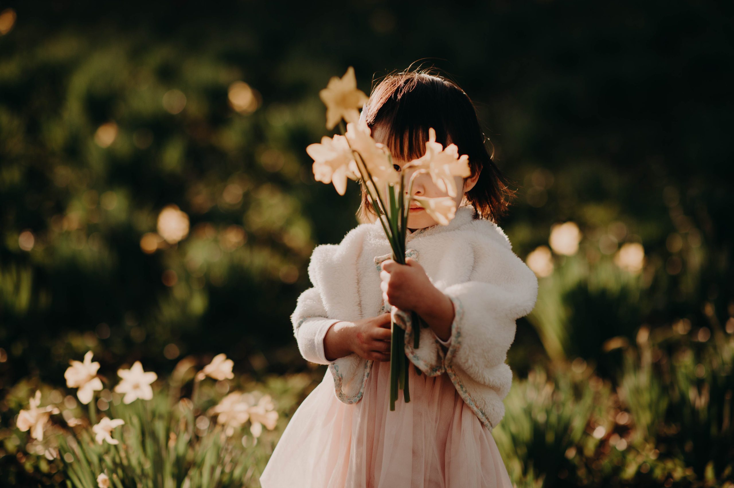 girl holding daffodil bouquet
