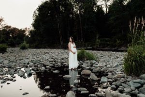 Pregnant woman standing in river