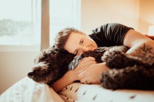 Woman and dog snuggling