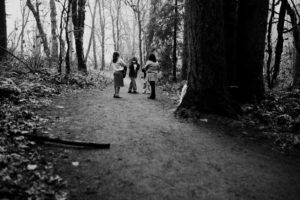 Family on a trail in woods