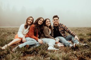 Four teen children sit ing in the fog
