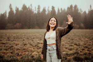Girl in field laughing