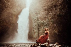 Woman in front of waterfall