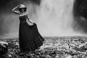 Woman in BNW in front of waterfall