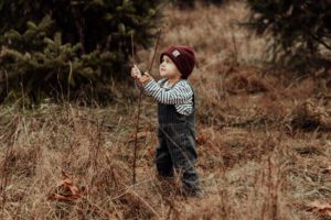 Little boy holding a stick