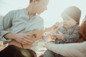 Dad playing guitar for son