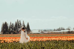 Girl spinning in tulips field