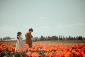 Boy and girl in red tulips