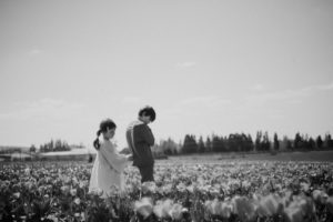 black and white image of girl and boy in tulips