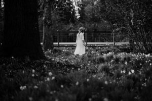 Woman walking away in flower field