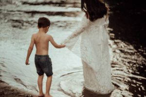Mom and son holding hands in the water