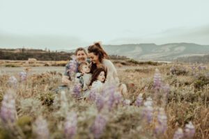 Family sitting in wild lupine