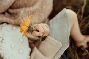 Little girl holding a wildflower