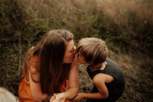 Mom kissing son