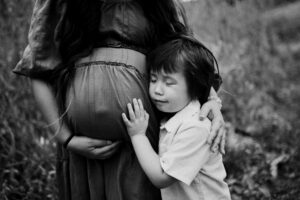 Boy touching Pregnant mamas belly