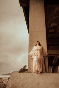 Woman model under the bridge at the coast