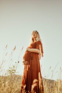 Pregnant mama in a field of grass
