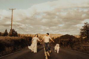 Man, wife and dog running down an abandoned road