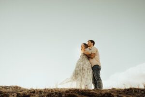 Pregnant woman and husband standing in the wind